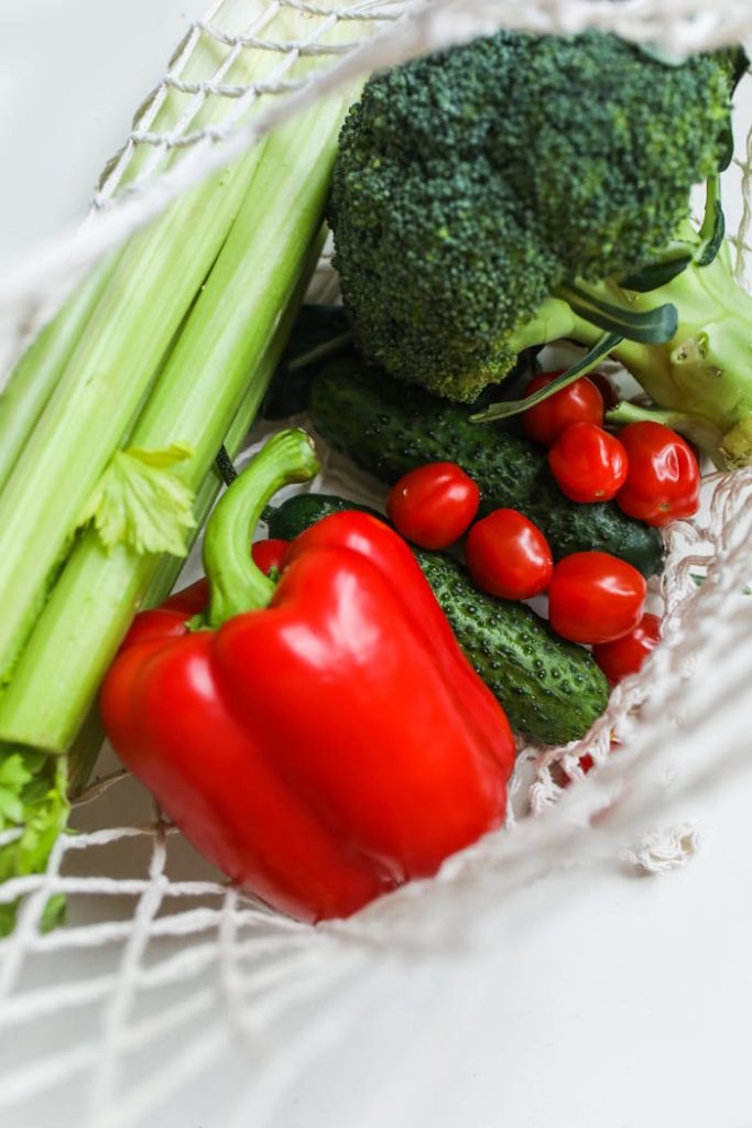 The Art of Drawing Readers In: Your attractive post title goes here A vibrant mix of fresh vegetables including broccoli, bell peppers, and cucumbers in a net bag.