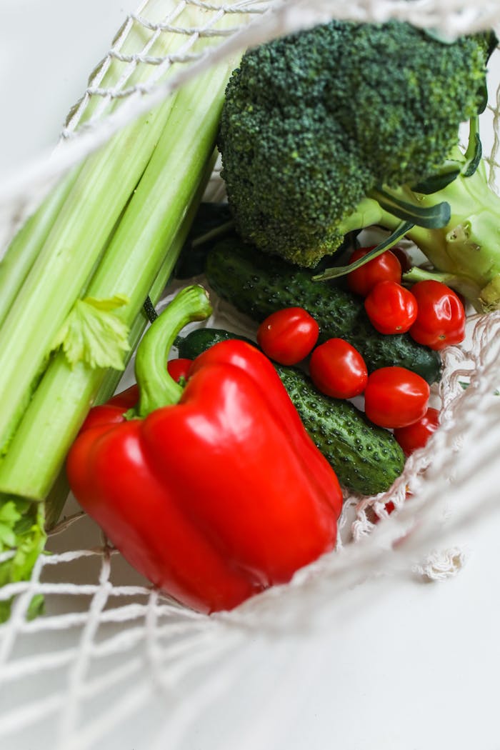The Art of Drawing Readers In: Your attractive post title goes here A vibrant mix of fresh vegetables including broccoli, bell peppers, and cucumbers in a net bag.